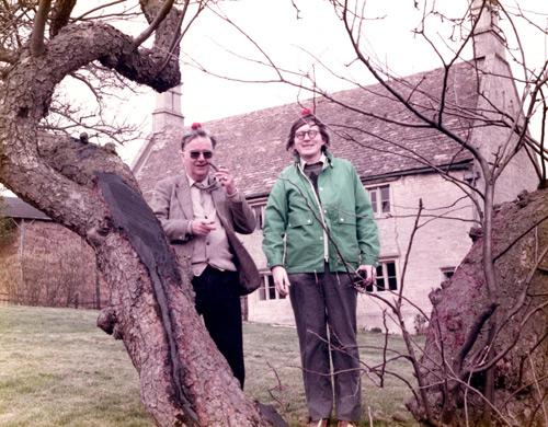 Gordon and Fergus Campbell smiling next to a tree in front of Isaac Newton’s cottage.